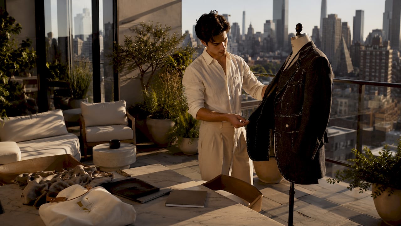 Designer inspecting jacket in New York studio