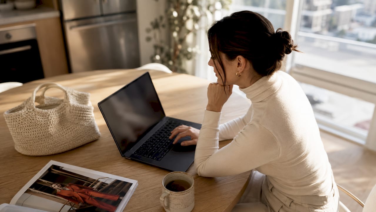 Woman shopping luxury fashion online at home