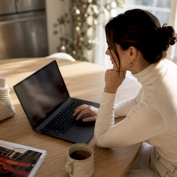 Woman shopping luxury fashion online at home