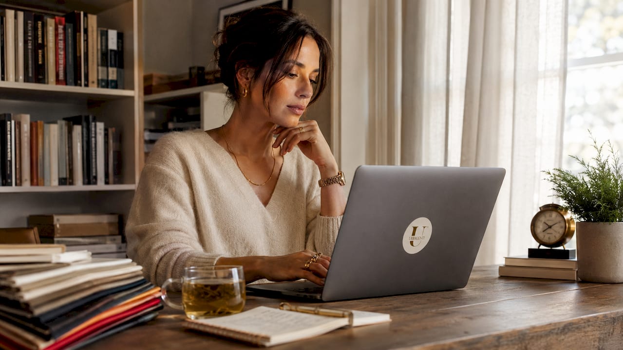 Woman browsing designer retailer websites at home