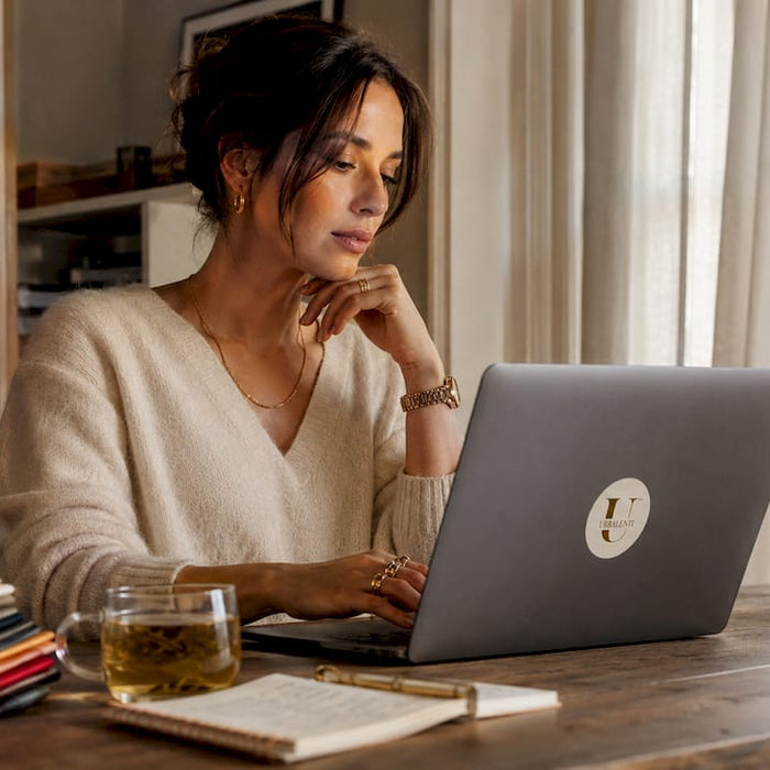 Woman browsing designer retailer websites at home