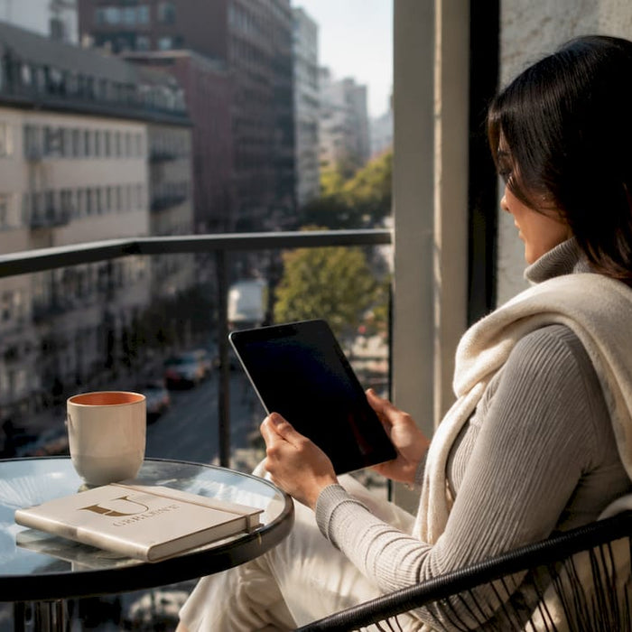 Woman browsing Italian designer shoes online tablet