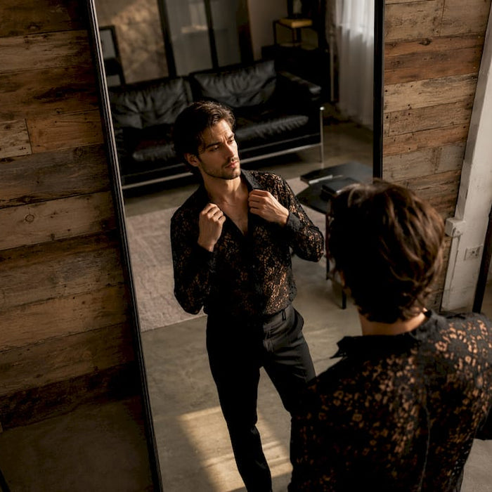 Man trying on designer shirt in modern apartment
