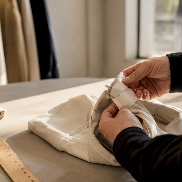 Hands inspecting fashion garment label closely