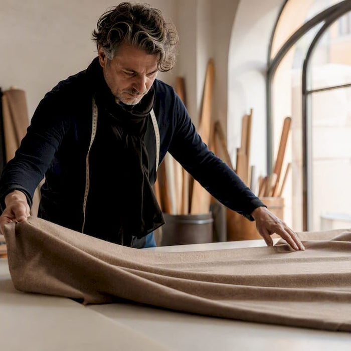 Hands sewing premium jacket in Milan atelier
