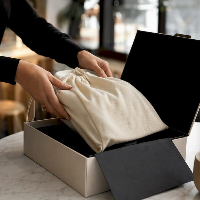 Hands packing luxury item for delivery