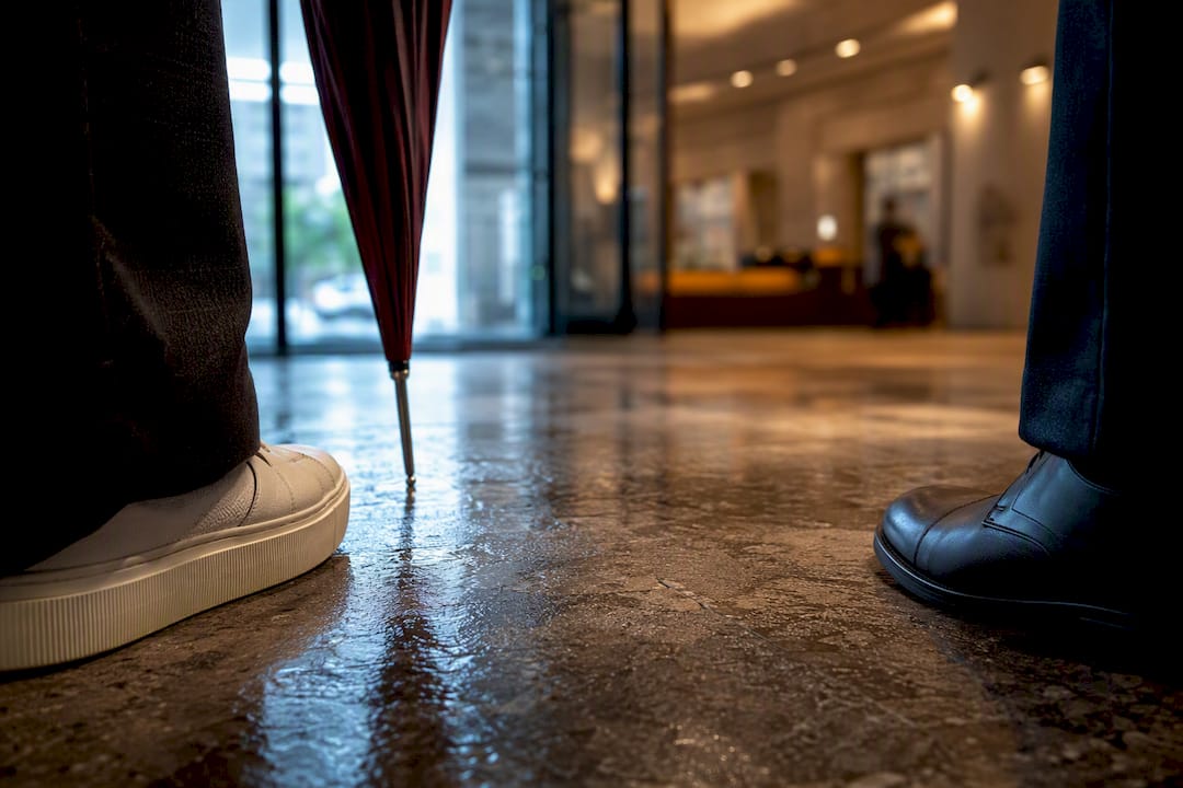 Anonymous footwear details at office lobby entrance