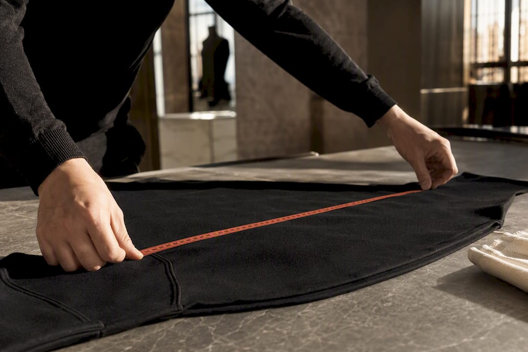 Measuring garment chest width with tape