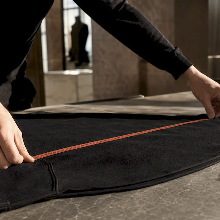 Measuring garment chest width with tape
