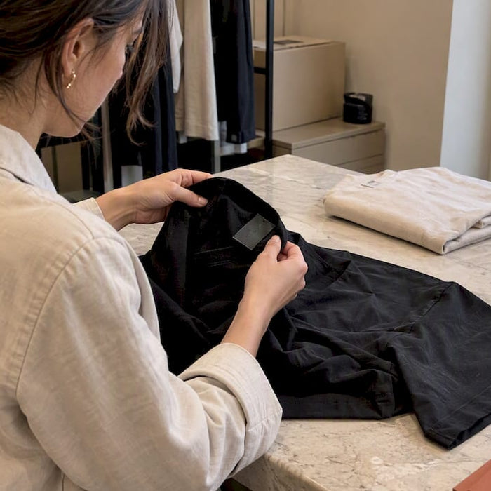 Collector inspecting Fear of God shirt authenticity