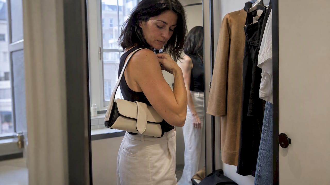 Collector checking the fit of a luxury handbag
