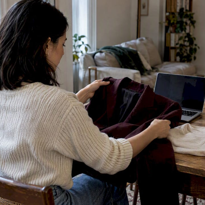 Shopper comparing curated designer garments at home