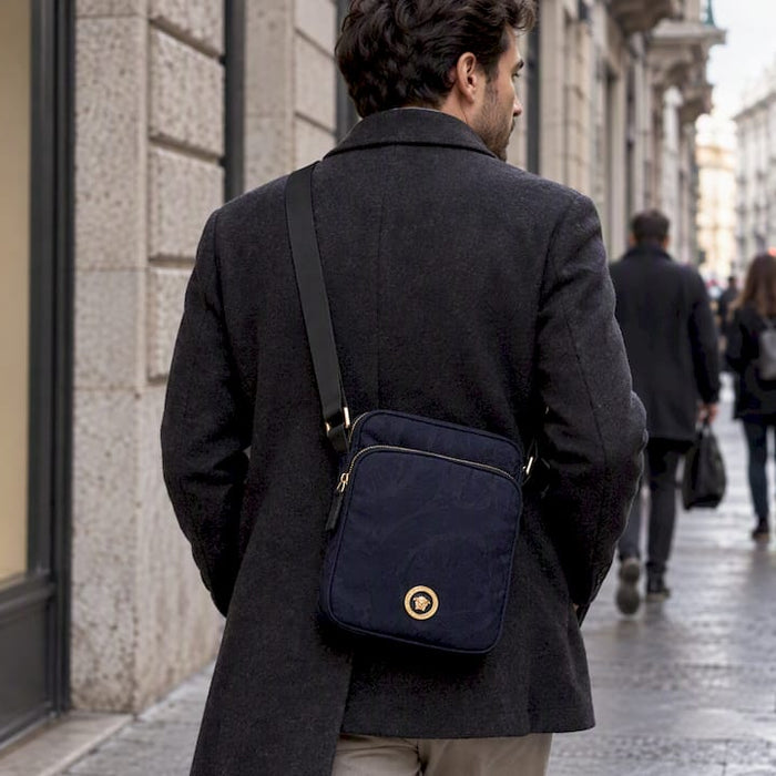 Man wearing a blue Versace crossbody bag