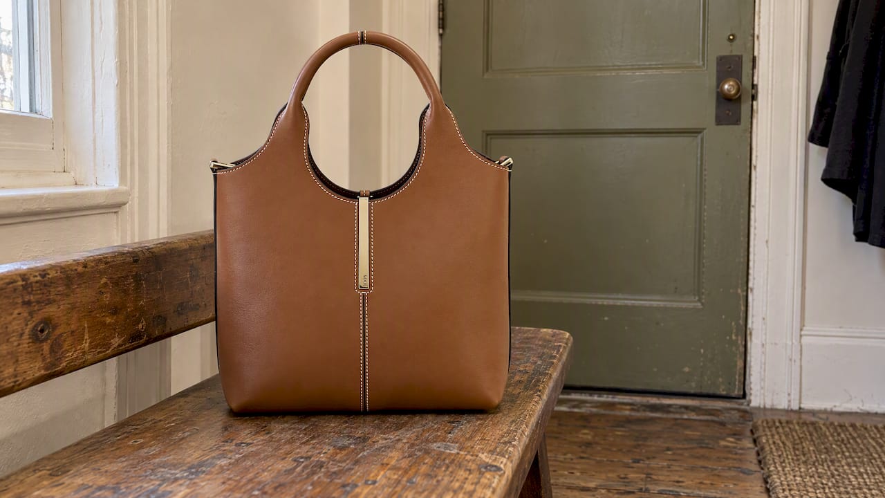 Tod's brown calfskin mini tote in an apartment entry
