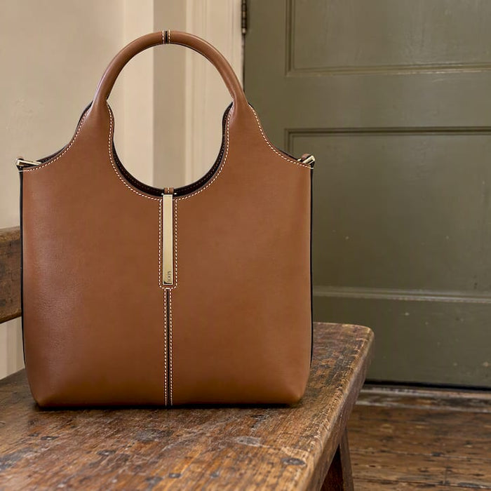 Tod's brown calfskin mini tote in an apartment entry