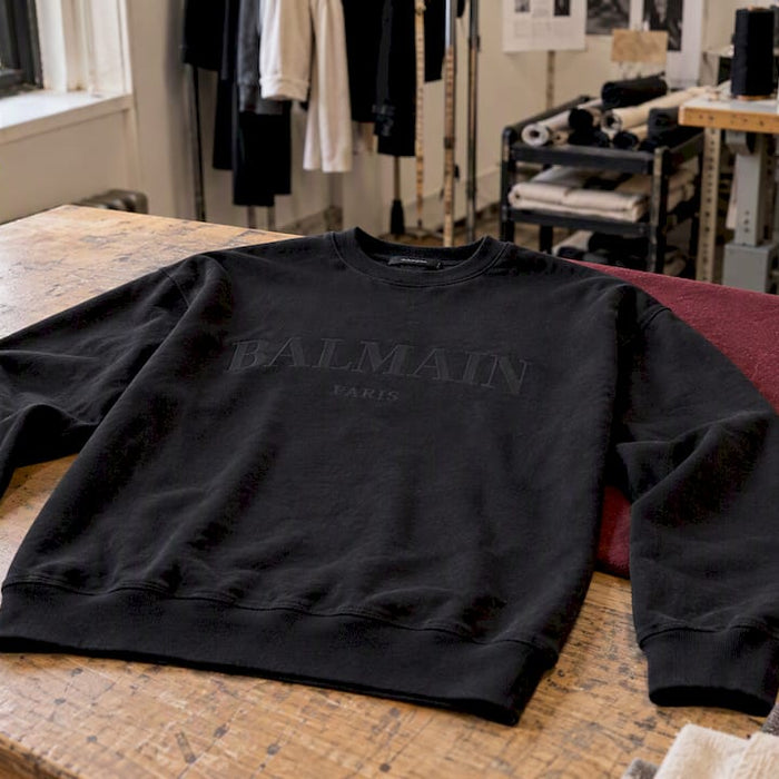 Balmain sweatshirt laid out for authenticity inspection