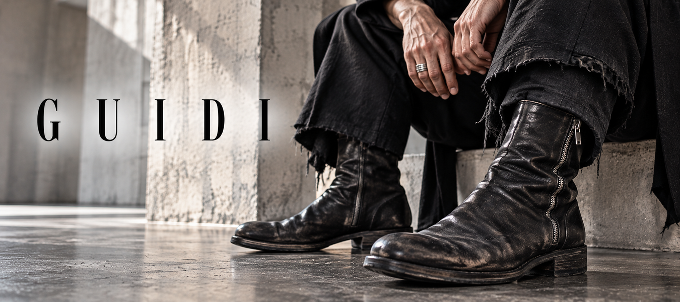 Guidi black leather boots with signature distressed finish worn in an industrial setting—Shop Guidi at urbalenti.
