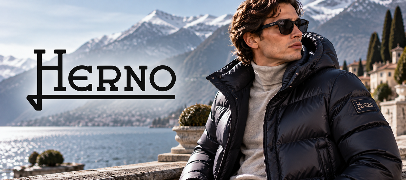 Herno luxury fashion designer navy puffer jacket worn by a man overlooking an alpine lake and mountains—Shop Herno luxury fashion designer shipped from Italy at Urbalenti.