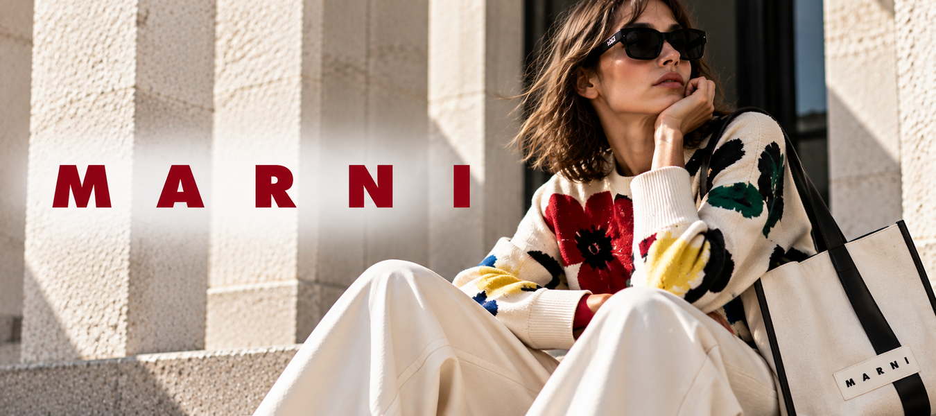 Marni women’s fashion campaign featuring a model in a colorful floral sweater, white trousers, sunglasses, and a Marni logo tote bag; Shop online Fashion designer Marni shipped from Europe at Urbalenti