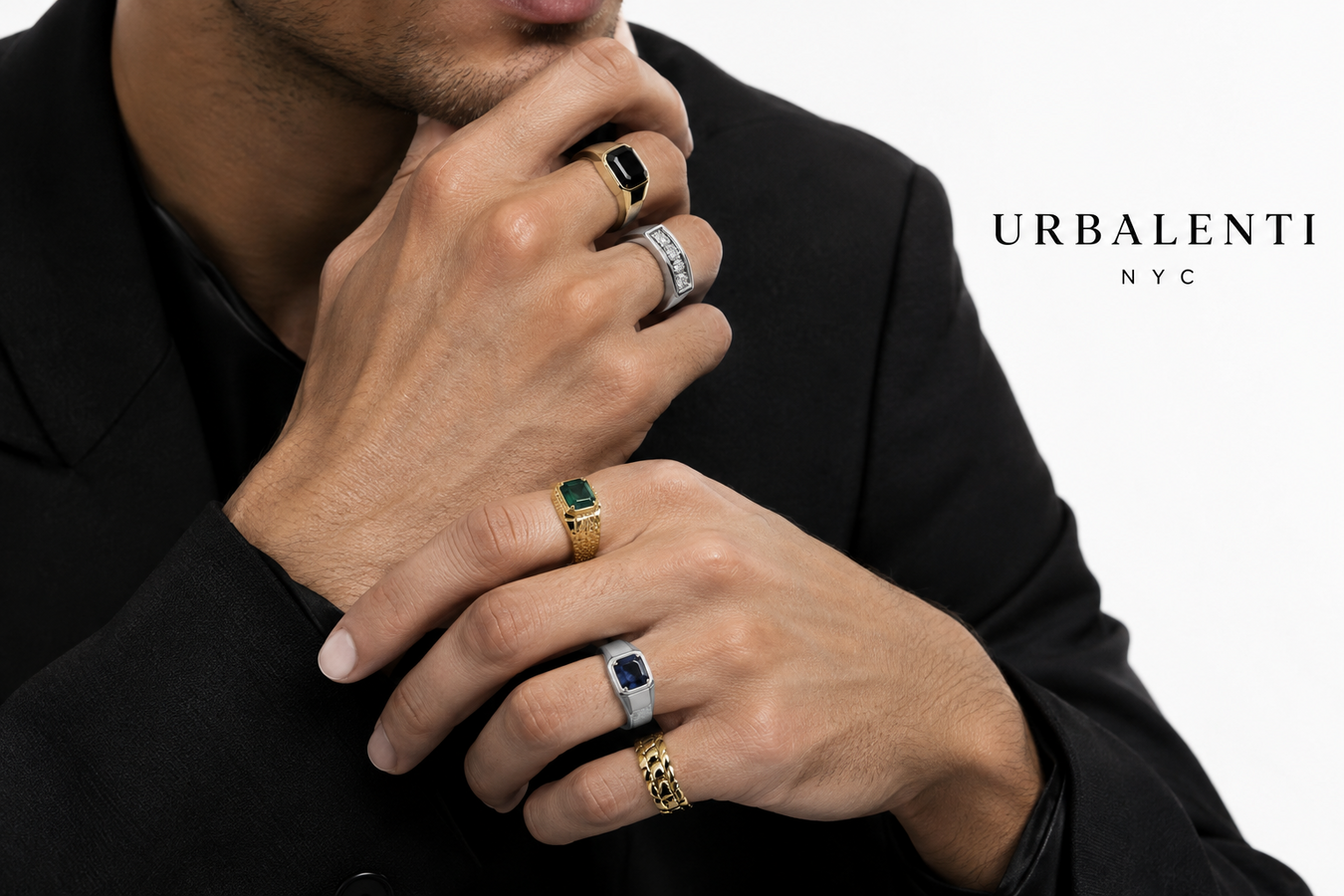 Model wearing multiple gold and silver statement rings with gemstone details against a black blazer—explore Designer Rings for Men and Shop Designer Rings for Men | Urbalenti NYC.
