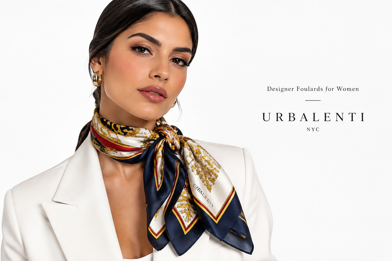 Designer Foulards for Women featuring a woman in a white blazer wearing a luxurious multicolor patterned silk foulard; Shop Designer Foulards for Women at urbalenti NYC.