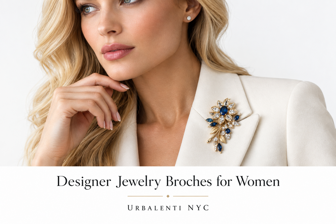 Elegant woman wearing a blue and gold floral brooch on a white blazer, featured in Designer Jewelry Broches for Women. Shop Designer Jewelry Broches for Women at Urbalenti NYC.