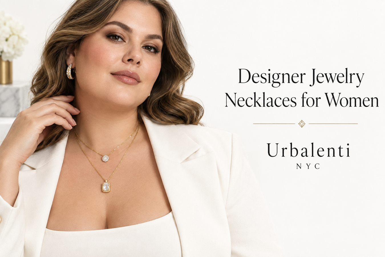 Woman wearing layered gold pendant necklaces with a white blazer, showcasing Designer Jewelry Necklaces for Women—Shop Designer Jewelry Necklaces for Women at Urbalenti NYC.