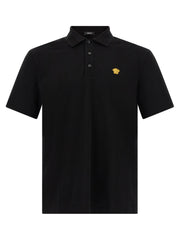 Front view of the Versace Medusa Polo Shirt featuring the iconic Medusa logo patch in a striking black color, perfect for the Fall - Winter 2026/2027 collection by Versace. Ideal for fashion-forward men looking to elevate their wardrobe. Men > Clothing > Shirts.