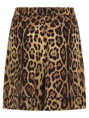Dolce & Gabbana Leopard Print Silk Bermuda Shorts for Women shown from the back in brown stretch silk with leopard print, black piping, and an elastic waistband. Dolce & Gabbana Silk Shorts for Women, Urbalenti NYC, 13879, 79680700467, Bermuda - Shorts - Clothing, Brown, Clothing, Discount_40-49, Dolce & Gabbana, in-stock, IT40, IT48, New with tags, Shorts - Clothing, Women.