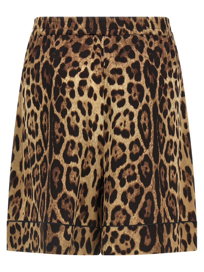 Dolce & Gabbana Leopard Print Silk Bermuda Shorts for Women shown from the back in brown stretch silk with leopard print, black piping, and an elastic waistband. Dolce & Gabbana Silk Shorts for Women, Urbalenti NYC, 13879, 79680700467, Bermuda - Shorts - Clothing, Brown, Clothing, Discount_40-49, Dolce & Gabbana, in-stock, IT40, IT48, New with tags, Shorts - Clothing, Women.