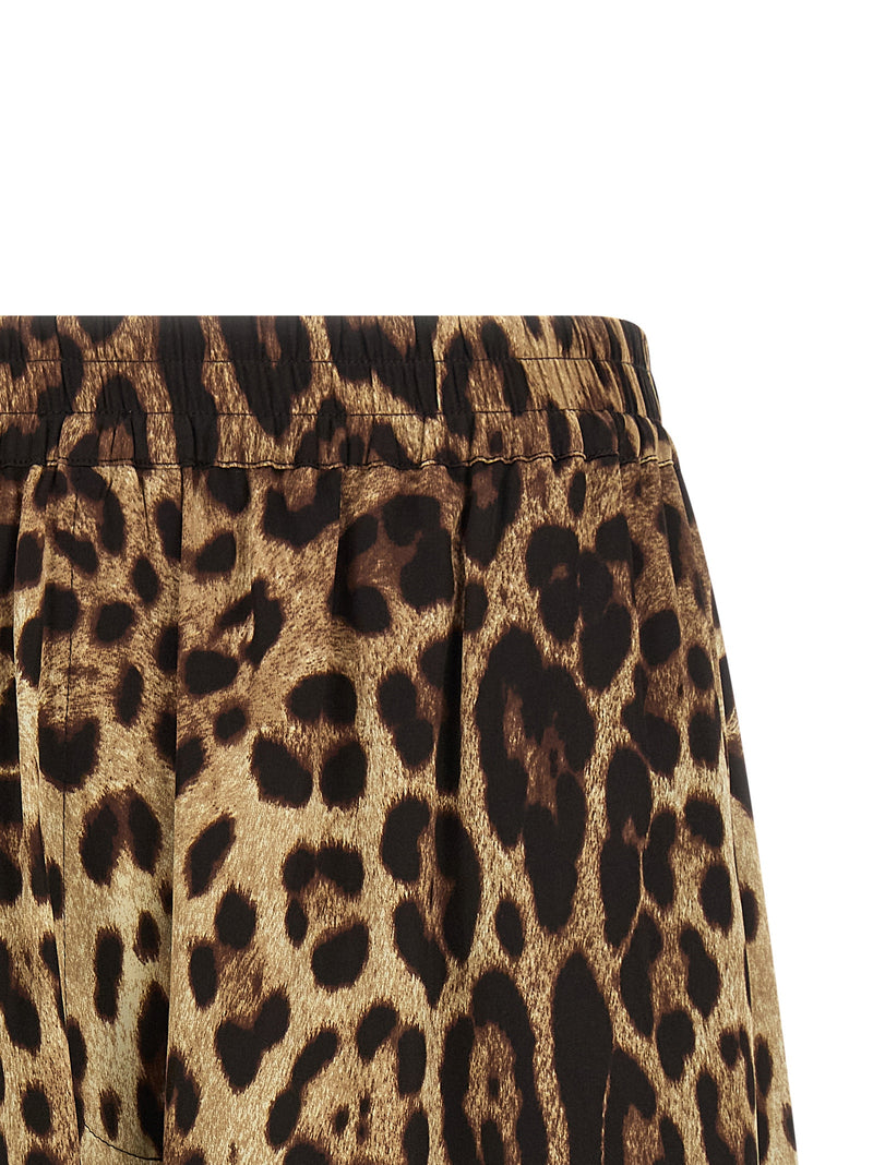 Close-up of the Dolce & Gabbana Leopard Print Silk Bermuda Shorts for Women showing the brown leopard-print silk fabric, gathered elastic waistband, and tailored side detail. Dolce & Gabbana Silk Shorts for Women, Urbalenti NYC, 13879, 79680700467, Bermuda - Shorts - Clothing, Brown, Clothing, Discount_40-49, Dolce & Gabbana, in-stock, IT40, IT48, New with tags, Shorts - Clothing, Women.