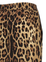 Close-up side view of Dolce & Gabbana Leopard Print Silk Bermuda Shorts for Women featuring brown leopard-print stretch silk, elastic waistband, and black piping. Dolce & Gabbana Silk Shorts for Women, Urbalenti NYC, 13879, 79680700467, Bermuda - Shorts - Clothing, Brown, Clothing, Discount_40-49, Dolce & Gabbana, in-stock, IT40, IT48, New with tags, Shorts - Clothing, Women.