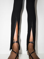 032C Black Front Zip Leggings with Zipped Pockets & Elastic Waistband, featuring stylish slits at the cuffs, showcased on a model's legs.