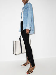 032C Black Front Zip Leggings with Zipped Pockets & Elastic Waistband, styled with a denim jacket and large tote bag on a model.