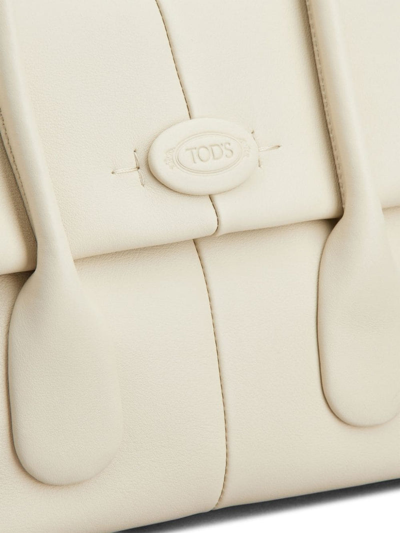 Close-up of the signature detailing on Tod's Di Leather Tote Bag, showcasing the brand's commitment to quality and style. Perfect for women who cherish luxury and practicality in their accessories, categorized under Women > Bags > Shopper for Spring - Summer 2024.