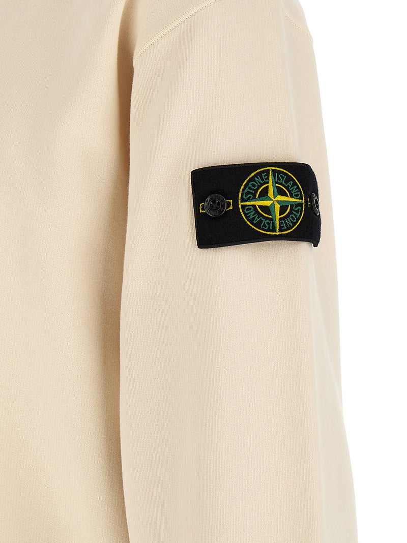 Close-up of the iconic Stone Island compass badge on the sleeve of the Stone Island White Cotton Sweatshirt for Men | White, showcasing premium white cotton construction; a distinctive Stone Island Sweatshirt for Men with 13879, 79680700467, Clothing, Discount_30-39, in-stock, L, M, Men, New with tags, Stone Island, Sweaters - Clothing, Sweatshirts - Sweaters - Clothing, White.