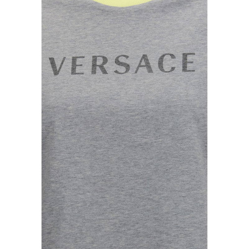 Close-up of the Versace logo on the gray cotton Versace Gray Cotton T-Shirt for womens | Gray, highlighting the premium logo detail of this Versace T-Shirt for womens.