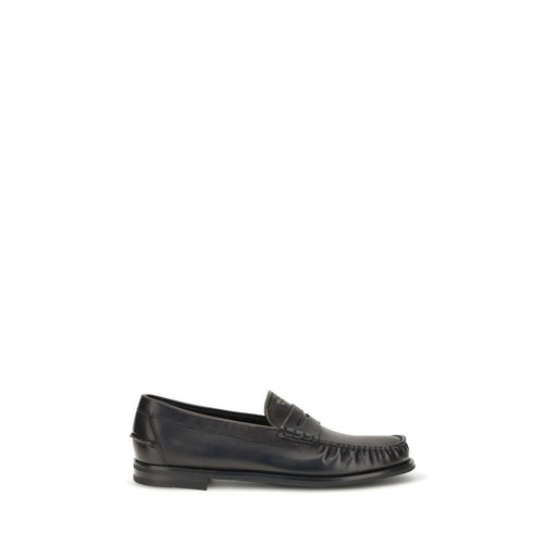 Side profile of Prada Vintage Black Calf Leather Slip-On Loafers, featuring Prada Slip-On Loafers in black calf leather with a rounded toe, vamp strap, distressed finish, and layered sole. Urbalenti NYC, 13879, 79661334579, Black, Discount_30-39, EU39.5/US6.5, EU39/US6, EU40.5/US7.5, EU40/US7, EU41.5/US8.5, EU41/US8, EU42.5/US9.5, EU42/US9, EU43.5/US10.5, in-stock, Loafers - Shoes, Men, New with tags, Prada, Shoes, Slip-On Loafers - Loafers - Shoes.