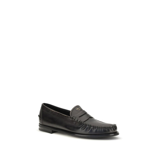 Front three-quarter view of Prada Vintage Black Calf Leather Slip-On Loafers, showcasing Prada Slip-On Loafers with a classic vamp strap, rounded moc toe, laminated Prada logo, and soft monochromatic black leather design. Urbalenti NYC, 13879, 79661334579, Black, Discount_30-39, EU39.5/US6.5, EU39/US6, EU40.5/US7.5, EU40/US7, EU41.5/US8.5, EU41/US8, EU42.5/US9.5, EU42/US9, EU43.5/US10.5, in-stock, Loafers - Shoes, Men, New with tags, Prada, Shoes, Slip-On Loafers - Loafers - Shoes.
