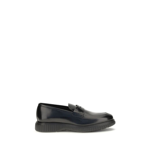 Side view of Ferragamo Black Calf Leather Gancini Slip-On Loafers, Ferragamo Slip-On Loafers in polished black calf leather with raised Gancini detail and lugged rubber sole. Available at Urbalenti NYC, style 13879, item 79661334579, color Black, Discount_40-49, sizes EU39/US6, EU40/US7, EU41.5/US8.5, EU41/US8, EU42.5/US9.5, EU42/US9, EU43/US10, and EU44/US11; Ferragamo, in-stock, Loafers - Shoes, Men, New with tags, Shoes, Slip-On Loafers - Loafers - Shoes.