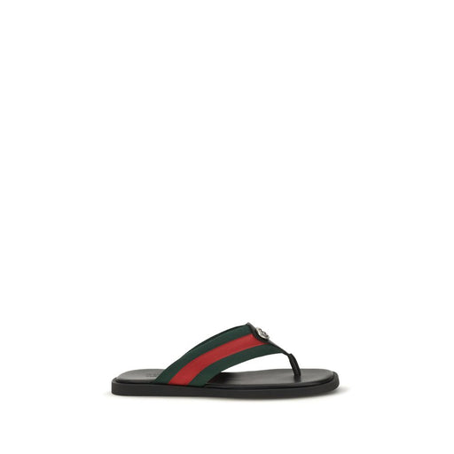 Gucci Maverik GG Interlocking Nylon Flip-Flop Sandals in Black, side view showing the low-profile rubber sole and green and red Web-inspired nylon strap. These Gucci Flip-Flop Sandals are listed at Urbalenti NYC, style 13879, SKU 79661334579, with Discount_30-39 pricing and sizes EU 38 | US 5, EU39.5/US6.5, EU39/US6, EU40.5/US7.5, EU40/US7, EU41.5/US8.5, EU41/US8, EU42.5/US9.5, EU42/US9, EU43/US10. Flip-Flop Sandals - Sandals - Shoes; Gucci, in-stock, Men, New with tags, Sandals - Shoes, Shoes.