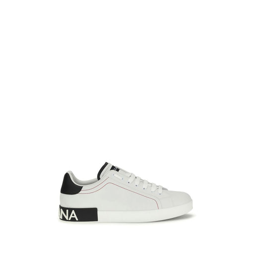 Side view of Dolce & Gabbana Portofino Sneakers, white leather low-top shoes with red stitching, black heel detail, branded sole, and laces. Dolce & Gabbana Portofino White Leather Low Top Sneakers, available at Urbalenti NYC, style 13879, 79661334579, Discount_50-59, EU45/US12, EU46/US13, in-stock, Low Tops - Sneakers - Shoes, Men, New with tags, Shoes, Sneakers - Shoes, White.