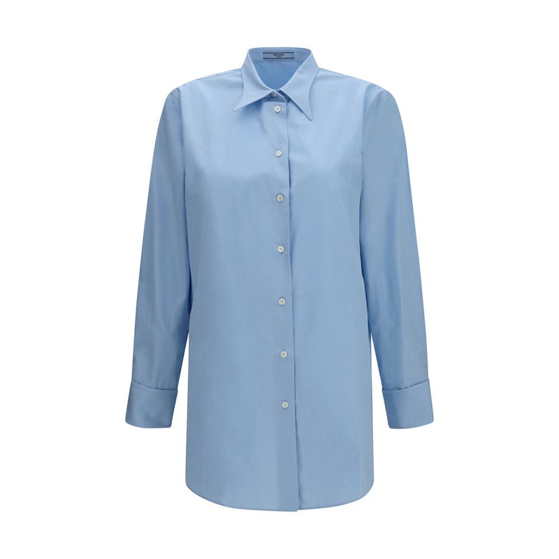 Front view of the Prada Cotton Poplin Shirt for Women, a light blue Prada Shirt for Women in 100% cotton with pointed collar, button fastening and French cuffs. Available at Urbalenti NYC, style 13879, 79661334579, Blue, Clothing, Discount_30-39, Dress Shirts - Shirts - Clothing, in-stock, IT38 | S, IT40 | M, New with tags, Prada, Shirts - Clothing, Women.