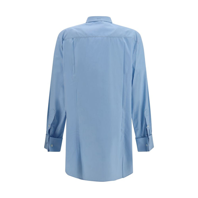 Back view of the Prada Cotton Poplin Shirt for Women, showcasing the light blue cotton poplin design, long sleeves and structured back. This Prada Shirt for Women is available at Urbalenti NYC, style 13879, 79661334579, Blue, Clothing, Discount_30-39, Dress Shirts - Shirts - Clothing, in-stock, IT38 | S, IT40 | M, New with tags, Prada, Shirts - Clothing, Women.