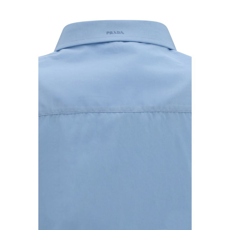 Close-up of the Prada logo collar on the Prada Cotton Poplin Shirt for Women in light blue cotton poplin. This refined Prada Shirt for Women is available at Urbalenti NYC, style 13879, 79661334579, Blue, Clothing, Discount_30-39, Dress Shirts - Shirts - Clothing, in-stock, IT38 | S, IT40 | M, New with tags, Prada, Shirts - Clothing, Women.