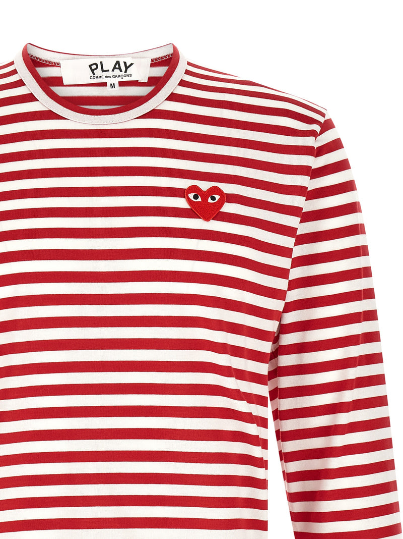Close-up of the embroidered red PLAY heart logo and ribbed neckline on the Comme Des Garçons Play Striped Long Sleeve T-Shirt for Men, a signature Comme Des Garçons Long Sleeve T-Shirt for Men in white and red. 13879, 79680700467, Clothing, Comme Des Garçons Play, Discount_30-39, in-stock, M, Men, New with tags, T-Shirts - Clothing, T-Shirts - T-Shirts - Clothing, White, XL, XXL, Urbalenti NYC.