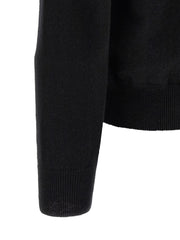 Close-up of the ribbed sleeve cuff and fine wool knit texture on the Comme Des Garçons Play Black Wool Cardigan for Men. This Comme Des Garçons Cardigan for Men is Black, New with tags, size L for Men, and in-stock under Cardigans - Sweaters - Clothing, Clothing, and Sweaters - Clothing; Discount_30-39, 13879, 79680700467.
