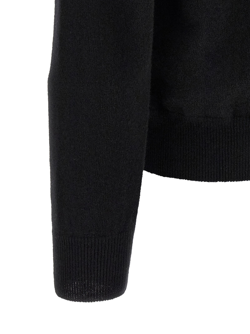 Close-up of the ribbed sleeve cuff and fine wool knit texture on the Comme Des Garçons Play Black Wool Cardigan for Men. This Comme Des Garçons Cardigan for Men is Black, New with tags, size L for Men, and in-stock under Cardigans - Sweaters - Clothing, Clothing, and Sweaters - Clothing; Discount_30-39, 13879, 79680700467.