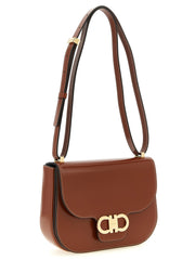 Ferragamo Double Gancini Leather Crossbody Bag for Women shown at an angle with its adjustable shoulder strap and gold-tone hardware, highlighting this refined brown Ferragamo Crossbody Bag for Women from Urbalenti NYC, 13879, 79680700467, Bags, Brown, Crossbody Bags - Bags, Discount_40-49, Ferragamo, in-stock, New with tags, Women.