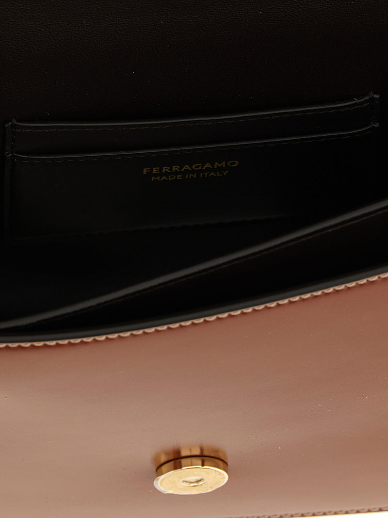 Interior view of the Ferragamo Double Gancini Leather Crossbody Bag for Women showing the lined compartment, slit pocket, Ferragamo Made in Italy branding, and gold-tone closure; a brown Ferragamo Crossbody Bag for Women from Urbalenti NYC, 13879, 79680700467, Bags, Brown, Crossbody Bags - Bags, Discount_40-49, Ferragamo, in-stock, New with tags, Women.
